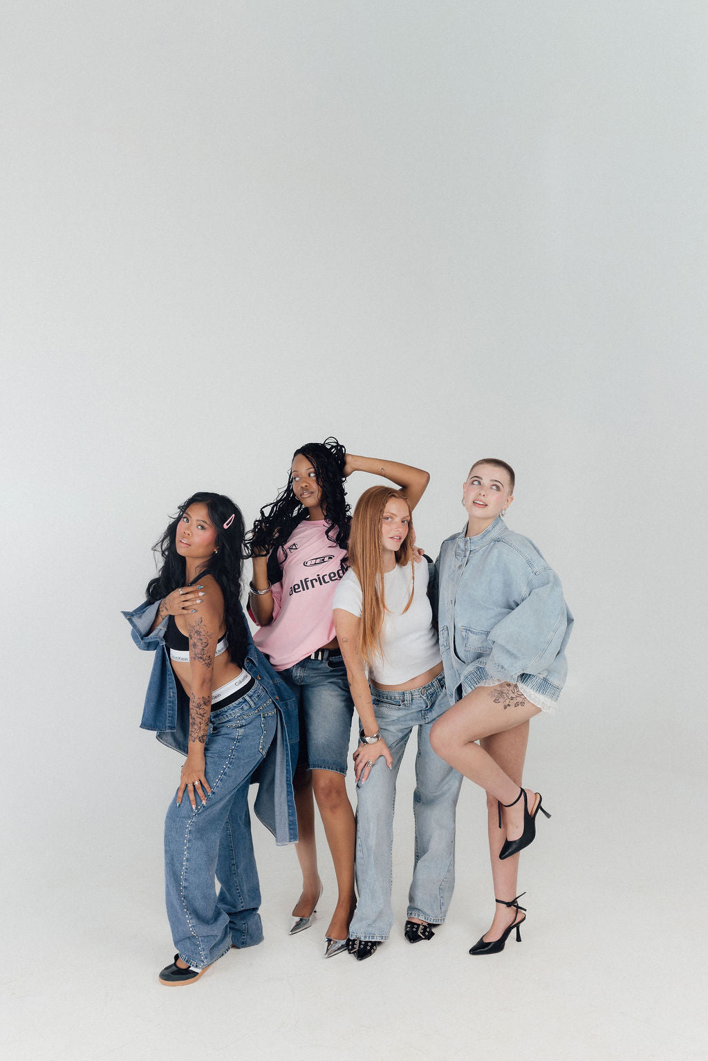 Four Ever Ink clients posing together in denim and streetwear